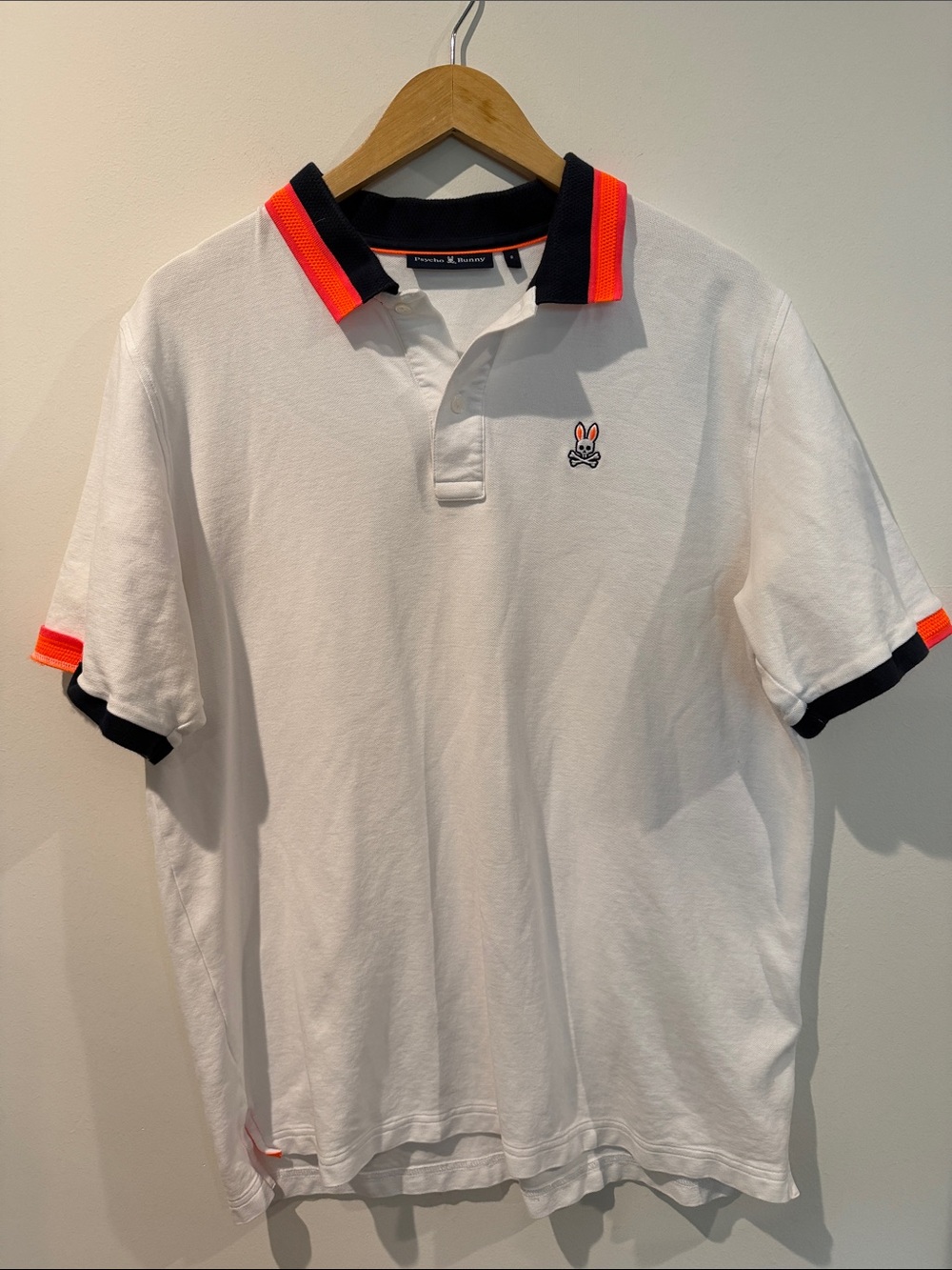 Psycho Bunny White Polo with Navy Collar and Neon Orange Trim
